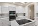 Modern kitchen featuring white cabinets, stainless steel appliances and quartz countertops at 760 N Ithica St, Gilbert, AZ 85233