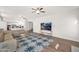 Bright living room featuring neutral sectional sofa, ceiling fans, and a decorative blue pattern rug at 760 N Ithica St, Gilbert, AZ 85233