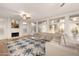 Open living room features a fireplace, large windows, and a beige sectional couch at 760 N Ithica St, Gilbert, AZ 85233