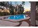 An inviting pool area with mature landscaping and decorative pavers at 760 N Ithica St, Gilbert, AZ 85233