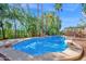 Beautiful pool with mature landscaping including large palm trees on a sunny day at 760 N Ithica St, Gilbert, AZ 85233