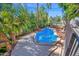 A beautiful backyard pool surrounded by lush tropical landscaping and concrete decking at 760 N Ithica St, Gilbert, AZ 85233