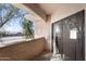 Balcony with view of street and surrounding trees and grass at 10030 W Indian School Rd # 218, Phoenix, AZ 85037