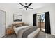 Relaxing bedroom featuring a comfortable bed, soft lighting, and access to a private balcony at 10030 W Indian School Rd # 218, Phoenix, AZ 85037