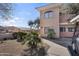 Inviting condo exterior featuring well-maintained landscaping and a neatly paved walkway at 10030 W Indian School Rd # 218, Phoenix, AZ 85037