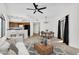 Bright living room with modern decor, an open floor plan, and views of the adjacent kitchen and outdoor patio at 10030 W Indian School Rd # 218, Phoenix, AZ 85037