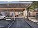 Designated parking area offers shaded parking spaces with greenery and walkways nearby at 10030 W Indian School Rd # 218, Phoenix, AZ 85037