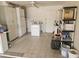 Organized garage storage area with shelving units and appliances, providing ample space and function at 10477 W Highwood Ln, Sun City, AZ 85373