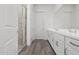 Sleek bathroom featuring a double vanity with quartz countertops, gray tiled floors, and a glass-enclosed shower at 11691 N Luckenbach St, Surprise, AZ 85388
