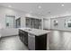 Modern kitchen island with stainless steel appliances, quartz countertops, and an open design layout at 11691 N Luckenbach St, Surprise, AZ 85388