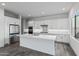 Contemporary kitchen with white cabinets, stainless steel appliances, a large island, and tiled backsplash at 11691 N Luckenbach St, Surprise, AZ 85388
