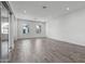Spacious living area with abundant natural light from large windows and sliding glass doors, complemented by tile floors at 11691 N Luckenbach St, Surprise, AZ 85388
