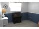 Bedroom featuring wainscoting and a wooden desk, perfect for a home office or study at 14609 N Montego Ct, Phoenix, AZ 85053