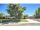 Charming single-story home with mature trees, a well-manicured lawn, and a long driveway at 14609 N Montego Ct, Phoenix, AZ 85053