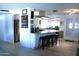 Open concept kitchen with a breakfast bar featuring granite countertops and bar stool seating at 14609 N Montego Ct, Phoenix, AZ 85053