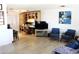 Spacious living room featuring an open plan, built-in shelves, hardwood floors, and modern furnishings at 14609 N Montego Ct, Phoenix, AZ 85053