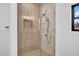 Elegant walk-in shower with glass enclosure and vertical and hexagonal pattern tile and modern fixtures at 2126 E Watson Dr, Tempe, AZ 85283