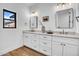Bright bathroom featuring double sink vanity, modern fixtures, and stylish wood-look tile floors at 2126 E Watson Dr, Tempe, AZ 85283
