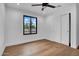 Bright bedroom with sliding door closet, ceiling fan, and hardwood flooring at 2126 E Watson Dr, Tempe, AZ 85283
