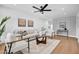 Bright living room with a ceiling fan, modern decor, light hardwood floors and lots of natural light at 2126 E Watson Dr, Tempe, AZ 85283