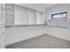 Spacious walk-in closet with custom shelving, rod system, and natural light from single hung window at 2126 E Watson Dr, Tempe, AZ 85283