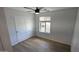 Cozy bedroom with wood-look floors, a closet, and a bright window at 4442 E Aire Libre Ave, Phoenix, AZ 85032