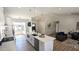 Modern kitchen with island, stainless appliances, and seamless flow into the living area at 4442 E Aire Libre Ave, Phoenix, AZ 85032