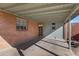 Covered back patio featuring brick and painted walls, and a wooden door at 2246 W Mulberry Dr, Phoenix, AZ 85015