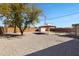 Relaxing backyard featuring desert landscaping, lounge area, storage shed, and mature tree at 2246 W Mulberry Dr, Phoenix, AZ 85015