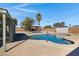 Inviting backyard pool featuring a lounge area, mature trees, and desert landscaping at 2246 W Mulberry Dr, Phoenix, AZ 85015