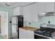 Well-lit kitchen with stainless steel appliances, white cabinetry, and wood countertops at 2246 W Mulberry Dr, Phoenix, AZ 85015