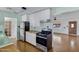 Kitchen with black appliances, white cabinets, butcher block countertops, and views of the yard at 2246 W Mulberry Dr, Phoenix, AZ 85015