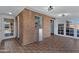 Bright sun room with a brick accent wall and vintage tile floors at 2246 W Mulberry Dr, Phoenix, AZ 85015