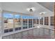 Sunroom with brick floors and multiple windows providing a view of the backyard pool at 2246 W Mulberry Dr, Phoenix, AZ 85015