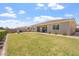 Large backyard with a lawn, covered patio, and privacy wall at 28389 N 131St Dr, Peoria, AZ 85383