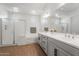Modern bathroom featuring a double vanity, walk-in shower, and soaking tub at 28389 N 131St Dr, Peoria, AZ 85383