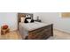 A bedroom with a wood bed frame, stuffed animal, and carpeted floor at 28389 N 131St Dr, Peoria, AZ 85383