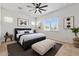 Modern bedroom with a patterned bed, large window, neutral color scheme and decor at 28389 N 131St Dr, Peoria, AZ 85383
