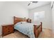 Comfortable bedroom with a wood frame bed, patterned bedding, and neutral carpet at 28389 N 131St Dr, Peoria, AZ 85383