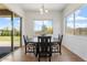 Cozy dining area with a dark wood table, set near sliding glass doors offering view of the backyard at 28389 N 131St Dr, Peoria, AZ 85383