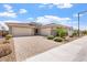 Beautiful single-story home featuring a three-car garage and lush landscaping at 28389 N 131St Dr, Peoria, AZ 85383