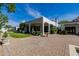 Expansive rear patio with lush landscaping, manicured lawn, and seamless indoor-outdoor living at 6620 E Stallion Rd, Paradise Valley, AZ 85253