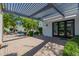 Covered patio with pavers and views of the pool and lush backyard, offering a seamless indoor-outdoor lifestyle at 6620 E Stallion Rd, Paradise Valley, AZ 85253
