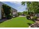 Lush green backyard with artificial grass and a patio area with seating and a gazebo at 6620 E Stallion Rd, Paradise Valley, AZ 85253