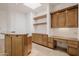 Wet bar area featuring custom cabinetry, granite countertops, built-in desk, and open shelves at 6620 E Stallion Rd, Paradise Valley, AZ 85253