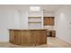 Entertainment space with custom wood bar and granite countertop, desk with upper and lower cabinets at 6620 E Stallion Rd, Paradise Valley, AZ 85253