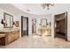 Bathroom with dual vanities, tile floor, decorative lighting, and large doorway at 6620 E Stallion Rd, Paradise Valley, AZ 85253