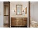 Bathroom featuring a wood vanity with a marble countertop and decorative sconces at 6620 E Stallion Rd, Paradise Valley, AZ 85253