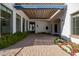 Beautiful brick courtyard with a pergola, large windows, and lush greenery providing a private outdoor space at 6620 E Stallion Rd, Paradise Valley, AZ 85253