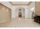 Spacious great room with travertine floors, high ceilings, and a fireplace with travertine surround at 6620 E Stallion Rd, Paradise Valley, AZ 85253